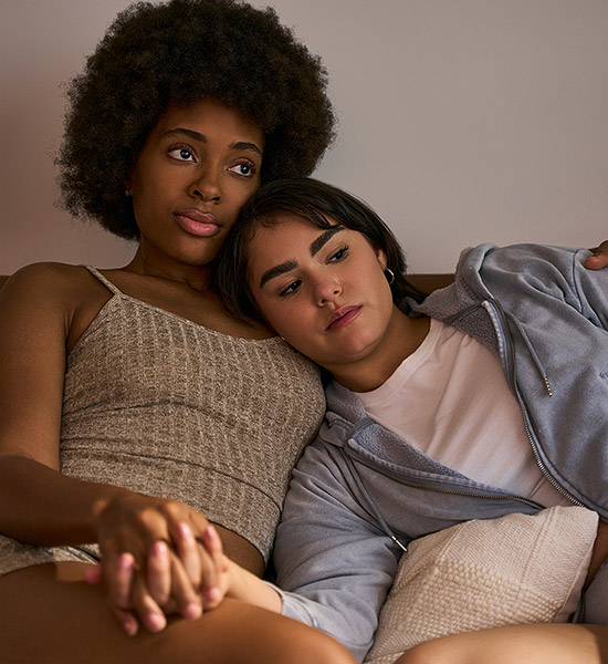 Couple cuddling waiting for pregnancy test results.